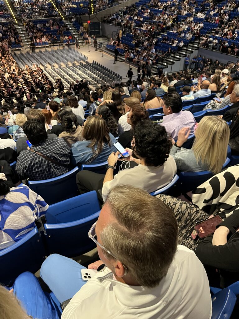 Guests attending a UC Irvine commencement ceremony access live captions and multilingual translation on their smartphones while seated in the arena.